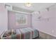 Comfortable bedroom with neutral colored carpet, a ceiling fan, and bright shelving at 3663 E Camden Ave, San Tan Valley, AZ 85140