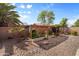 Backyard showing garden beds with covers, mature trees, and landscaping at 3663 E Camden Ave, San Tan Valley, AZ 85140