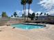 Pool area with volleyball net, trees, and mountain views at 39 Iron Ore Dr, Apache Junction, AZ 85119