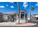 This home showcases a covered parking area, palm trees, and a well-manicured exterior at 39 Iron Ore Dr, Apache Junction, AZ 85119