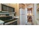 Kitchen featuring stainless steel appliances, light wood cabinets, and adjoining bedroom view at 39 Iron Ore Dr, Apache Junction, AZ 85119