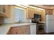 Well-lit kitchen with light wood cabinetry, stainless steel appliances, and tiled backsplash at 39 Iron Ore Dr, Apache Junction, AZ 85119