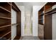 Spacious walk-in closet with custom shelving and adjacent bathroom for convenient dressing at 4745 N Scottsdale Rd # 3008, Scottsdale, AZ 85251