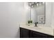 Bathroom features a dark vanity with a white countertop and modern black faucet at 500 N Roosevelt Ave # 102, Chandler, AZ 85226