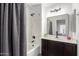 Bathroom with a shower and tub combination featuring a dark vanity with a neutral-colored countertop at 500 N Roosevelt Ave # 102, Chandler, AZ 85226