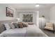 Bright bedroom featuring an upholstered bed, modern lamp, and soft natural light from a large window at 500 N Roosevelt Ave # 102, Chandler, AZ 85226