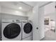 Convenient laundry room with modern, front loading Samsung washer and dryer and built-in shelving at 500 N Roosevelt Ave # 102, Chandler, AZ 85226