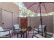 Enclosed outdoor patio with comfortable seating, ideal for relaxation and entertaining under an umbrella at 500 N Roosevelt Ave # 102, Chandler, AZ 85226