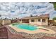 Inviting backyard pool surrounded by rock landscaping and a diving board at 5125 W Las Palmaritas Dr, Glendale, AZ 85302