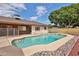 Backyard view of a refreshing pool, surrounded by a deck and lush landscaping at 5125 W Las Palmaritas Dr, Glendale, AZ 85302