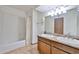 Bathroom featuring dual sinks, granite countertops, a shower-tub combo, and wood-grain flooring at 5125 W Las Palmaritas Dr, Glendale, AZ 85302