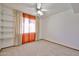 Bedroom with a ceiling fan, plush carpeting and a set of shelving for storage at 5125 W Las Palmaritas Dr, Glendale, AZ 85302