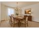 Formal dining room is complete with chandelier, modern window treatments and decorative art at 5125 W Las Palmaritas Dr, Glendale, AZ 85302