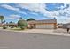 Charming single-story home with a well-manicured lawn, brick accents, and a three-car garage at 5125 W Las Palmaritas Dr, Glendale, AZ 85302