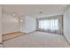 Bright living room featuring neutral carpet, white walls, and large windows with decorative curtains at 5125 W Las Palmaritas Dr, Glendale, AZ 85302