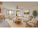 Bright living room features neutral color palette, ceiling fan and large windows providing ample natural light at 5125 W Las Palmaritas Dr, Glendale, AZ 85302
