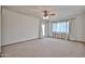 Bright living room with neutral carpet, ceiling fan, and a glass door leading to the outside at 5125 W Las Palmaritas Dr, Glendale, AZ 85302