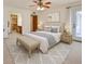 Comfortable main bedroom boasts a ceiling fan, patio access, and ensuite bath and walk-in closet at 5125 W Las Palmaritas Dr, Glendale, AZ 85302