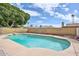 Beautiful pool area with cool, clear water, bordered by brick, rocks, and green foliage at 5125 W Las Palmaritas Dr, Glendale, AZ 85302