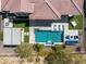 Aerial view showcases a refreshing pool with water feature, outdoor kitchen, and manicured landscaping at 5142 N 205Th Gln, Buckeye, AZ 85396