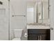 Modern bathroom featuring a dark wood vanity, mosaic tile backsplash, and a shower with marble-look tiles at 5142 N 205Th Gln, Buckeye, AZ 85396