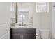 Bathroom boasting a dark cabinet vanity, decorative mirror, and neutral paint at 5142 N 205Th Gln, Buckeye, AZ 85396