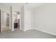 Bedroom leading to bathroom featuring neutral paint, plush carpet, and abundant natural light at 5142 N 205Th Gln, Buckeye, AZ 85396