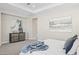 Relaxing bedroom featuring a decorative dresser, tray ceiling, neutral paint, and ample natural light at 5142 N 205Th Gln, Buckeye, AZ 85396