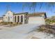 Elegant exterior view showing a spacious three-car garage and desert landscaping at 5142 N 205Th Gln, Buckeye, AZ 85396