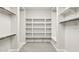 Walk-in closet with custom built-in shelving to maximize space and organization at 5142 N 205Th Gln, Buckeye, AZ 85396