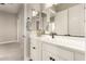 Modern bathroom with white cabinets, a black faucet, and a towel rack next to the mirror at 5700 N 202Nd Ln, Litchfield Park, AZ 85340