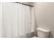 Neutral bathroom with a simple shower and toilet at 5700 N 202Nd Ln, Litchfield Park, AZ 85340