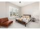 Serene bedroom with a large window, white plantation shutters, and cozy accent chair at 5700 N 202Nd Ln, Litchfield Park, AZ 85340