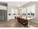 Elegant dining room featuring a live edge wood table, modern lighting, and ample natural light from the windows at 5700 N 202Nd Ln, Litchfield Park, AZ 85340