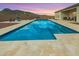 A refreshing backyard pool with a tanning ledge and stunning mountain views is perfect for relaxation at 5700 N 202Nd Ln, Litchfield Park, AZ 85340