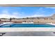 Inviting pool and patio with scenic views of the surrounding mountains and blue skies at 5700 N 202Nd Ln, Litchfield Park, AZ 85340