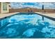 Large backyard pool reflecting the sky with desert landscaping at 5700 N 202Nd Ln, Litchfield Park, AZ 85340