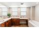 Bright bathroom featuring a double vanity, soaking tub, and ample counter space at 605 S Roosevelt St, Tempe, AZ 85281