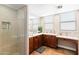 Bright bathroom featuring a double vanity, walk-in shower and a large mirror at 605 S Roosevelt St, Tempe, AZ 85281