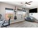 Inviting bedroom featuring large windows that frame views, a TV, and a cozy beanbag chair at 605 S Roosevelt St, Tempe, AZ 85281