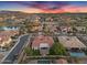 Aerial view of a residential neighborhood with homes with tile roofs, swimming pools, and a lake at 610 W Tonto Dr, Chandler, AZ 85248