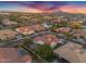 Aerial view of a residential neighborhood with homes with tile roofs, swimming pools, a lake and mountain views at 610 W Tonto Dr, Chandler, AZ 85248