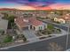 Aerial view of a home with a three-car garage, tile roof, and a well-maintained yard in a residential neighborhood at 610 W Tonto Dr, Chandler, AZ 85248