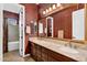 Bathroom featuring dual sinks, a large mirror, and a separate toilet and shower/tub area at 610 W Tonto Dr, Chandler, AZ 85248