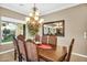 Formal dining room features large window, chandelier lighting, and traditional decor elements at 610 W Tonto Dr, Chandler, AZ 85248