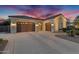 Stunning home featuring a three car garage and tile roof, beautifully illuminated at twilight at 610 W Tonto Dr, Chandler, AZ 85248