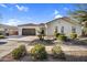 Exterior view of this home showing a spacious driveway, beautiful landscaping, and a tiled roof at 610 W Tonto Dr, Chandler, AZ 85248