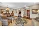 Elegant living room featuring hardwood floors, a crystal chandelier, and a formal dining area at 610 W Tonto Dr, Chandler, AZ 85248