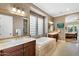 Elegant main bathroom with dual sinks, a soaking tub, and a separate shower with beautiful decorative tile at 610 W Tonto Dr, Chandler, AZ 85248