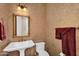 Elegant powder room featuring a pedestal sink and ornate wallpaper at 610 W Tonto Dr, Chandler, AZ 85248